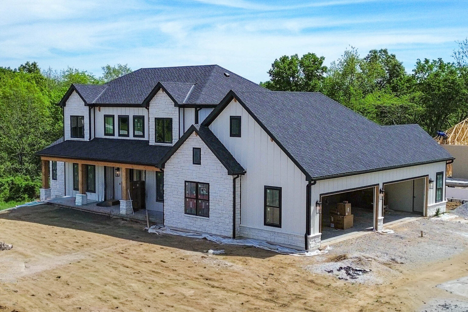 Aerial view of a Smithville, MO home with new black gutters and 3x4 downspouts.