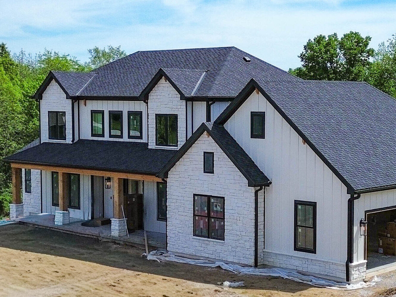 Aerial view of a Smithville, MO home with new black gutters and 3x4 downspouts.