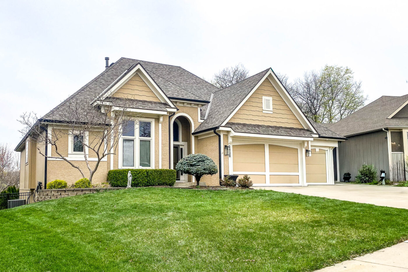 Kansas City residential home with new 5-inch matte black gutters installed for modern style and reliable water protection.
