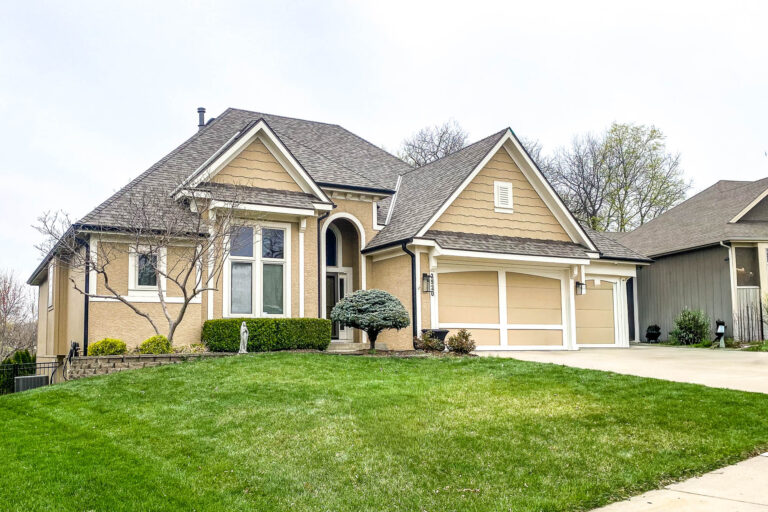 Kansas City residential home with new 5-inch matte black gutters installed for modern style and reliable water protection.