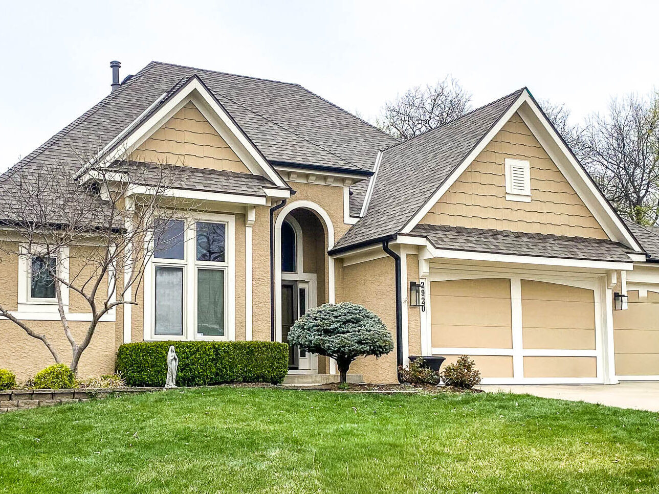 Kansas City residential home with new 5-inch matte black gutters installed for modern style and reliable water protection.