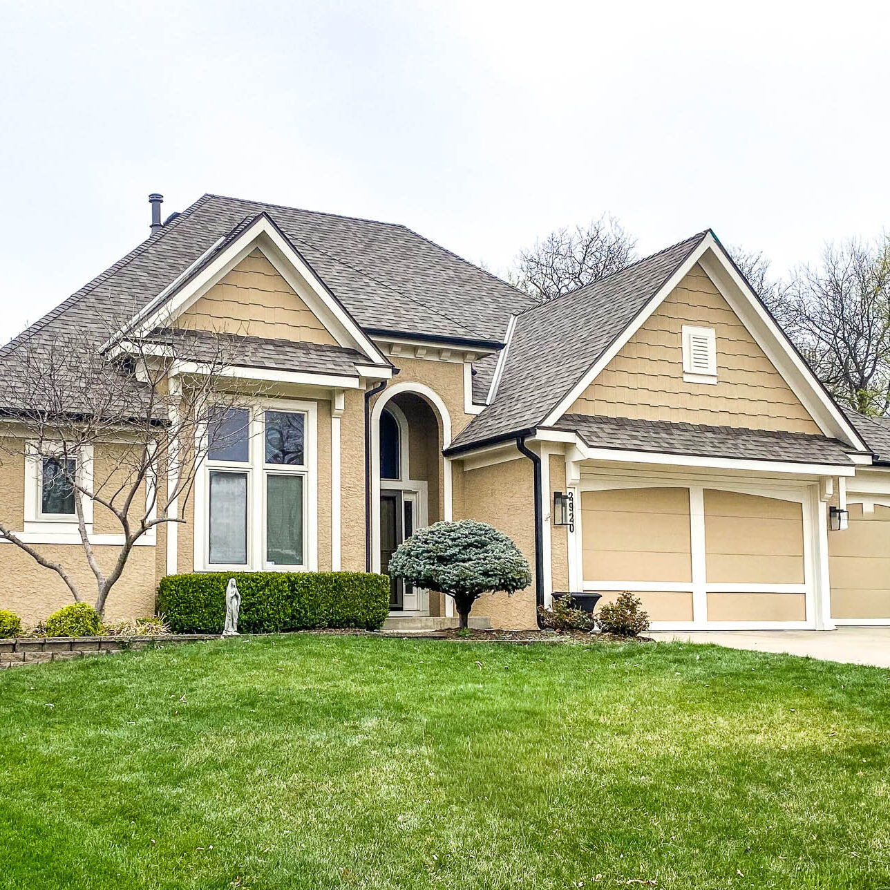 Kansas City residential home with new 5-inch matte black gutters installed for modern style and reliable water protection.
