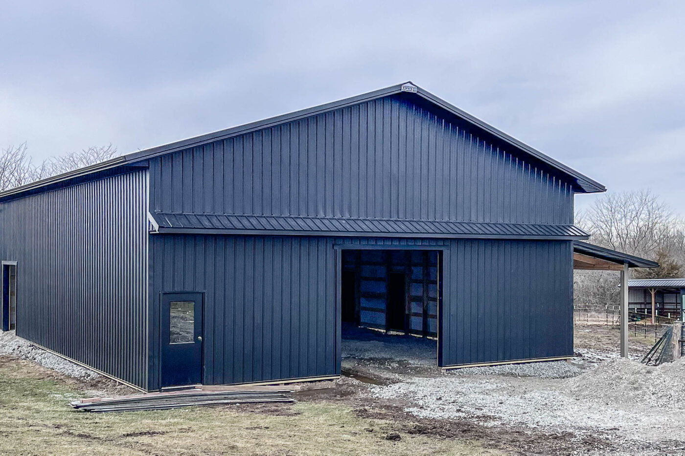 Side view of a large metal building with black seamless gutters in Cameron, MO.