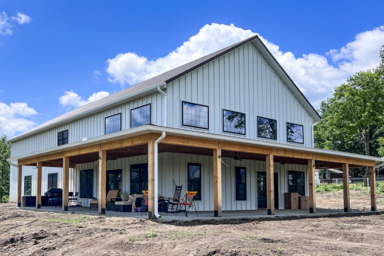 Two-story white home with 6-inch white gutters installed by Gutter Tech in Smithville, Missouri.