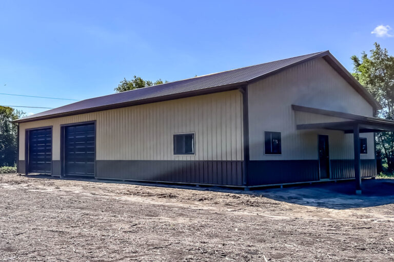 Large metal building with new 6-inch black seamless gutters installed by Gutter Tech in Smithville, Missouri.