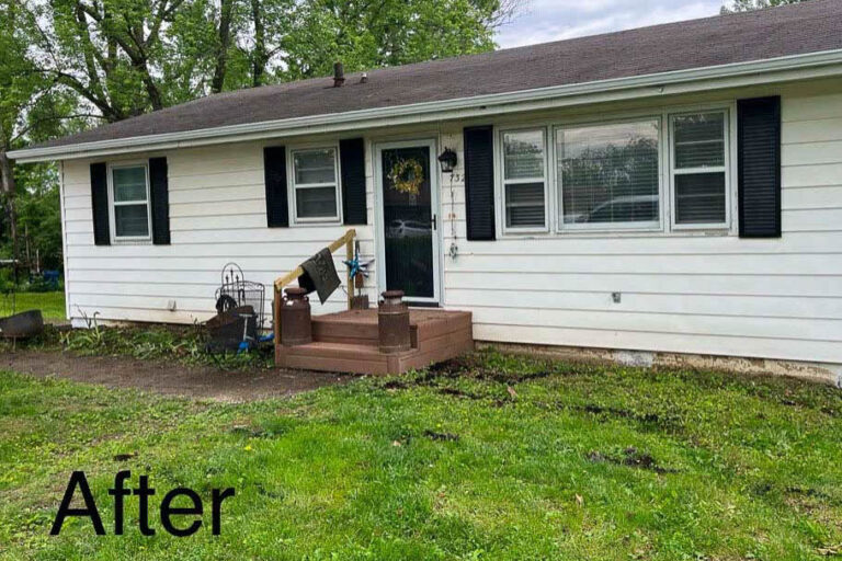 Front view of the same home in Excelsior Springs, MO, now featuring a newly installed white gutter system along the full roofline.