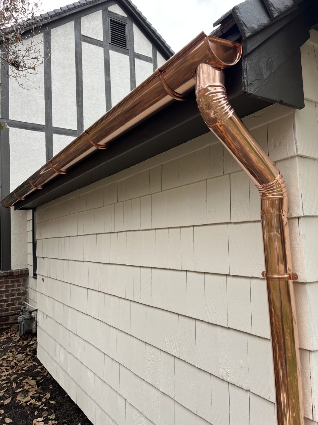 New 6 inch copper gutter installation with 4 inch copper downspout on a garage in Leawood, KS