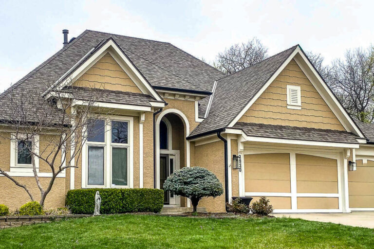 black gutters tan stucco house
