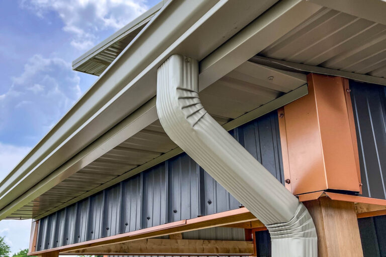 Close-up of clay seamless gutter and 3x4 downspout installed on a new home in Holden, Missouri.